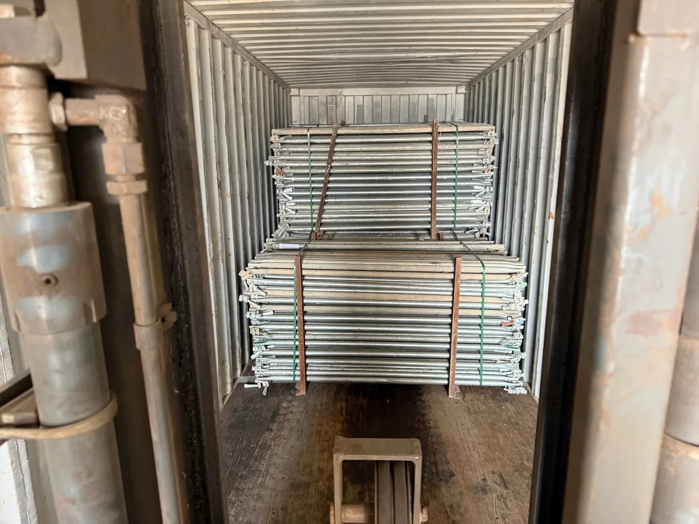 Bundled Ringlock scaffolding components loaded inside a shipping container